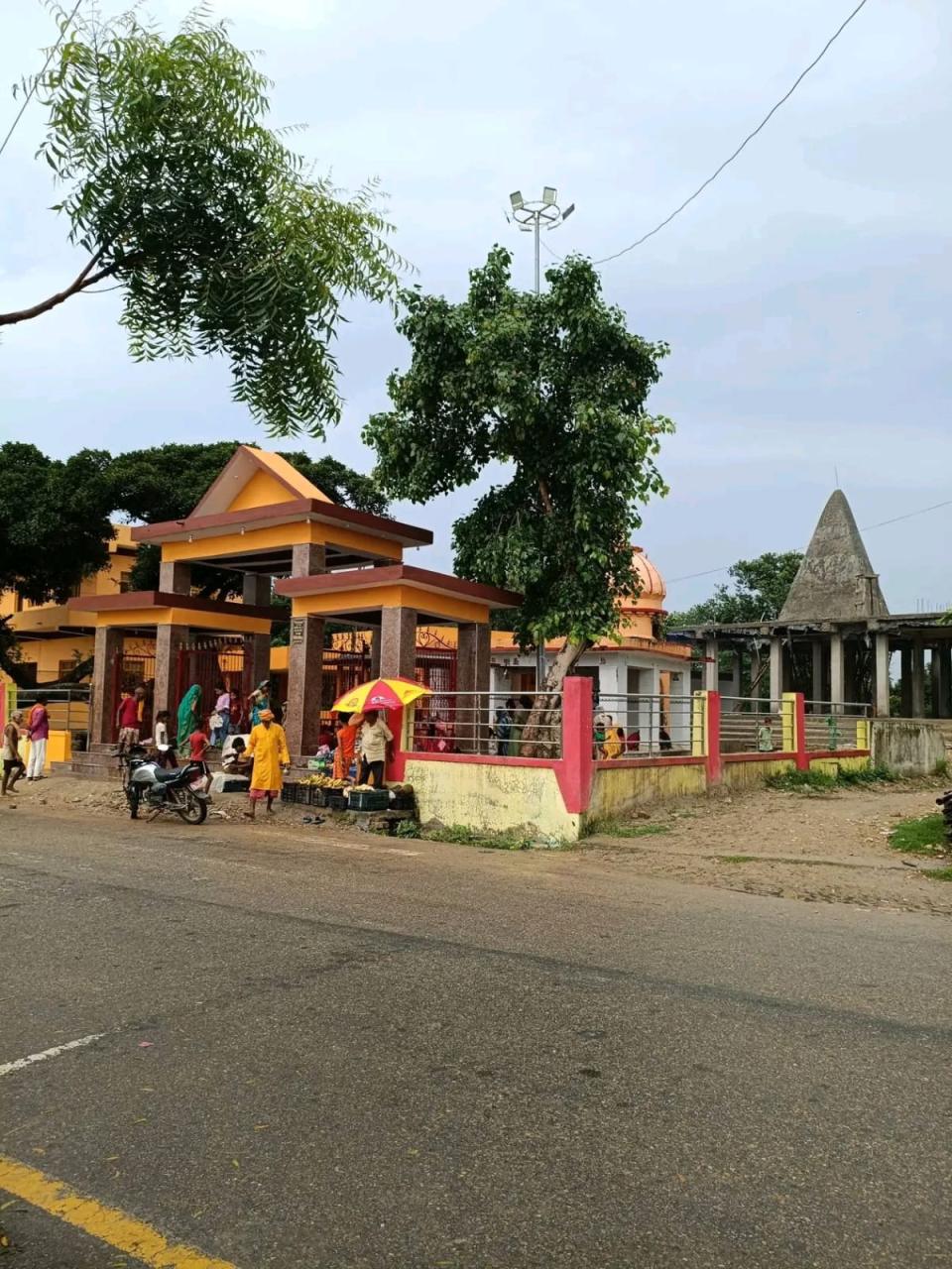 The full temple complex at Manara from across the road: the new gate, the domed shrine and the plain grey shikhar beside it