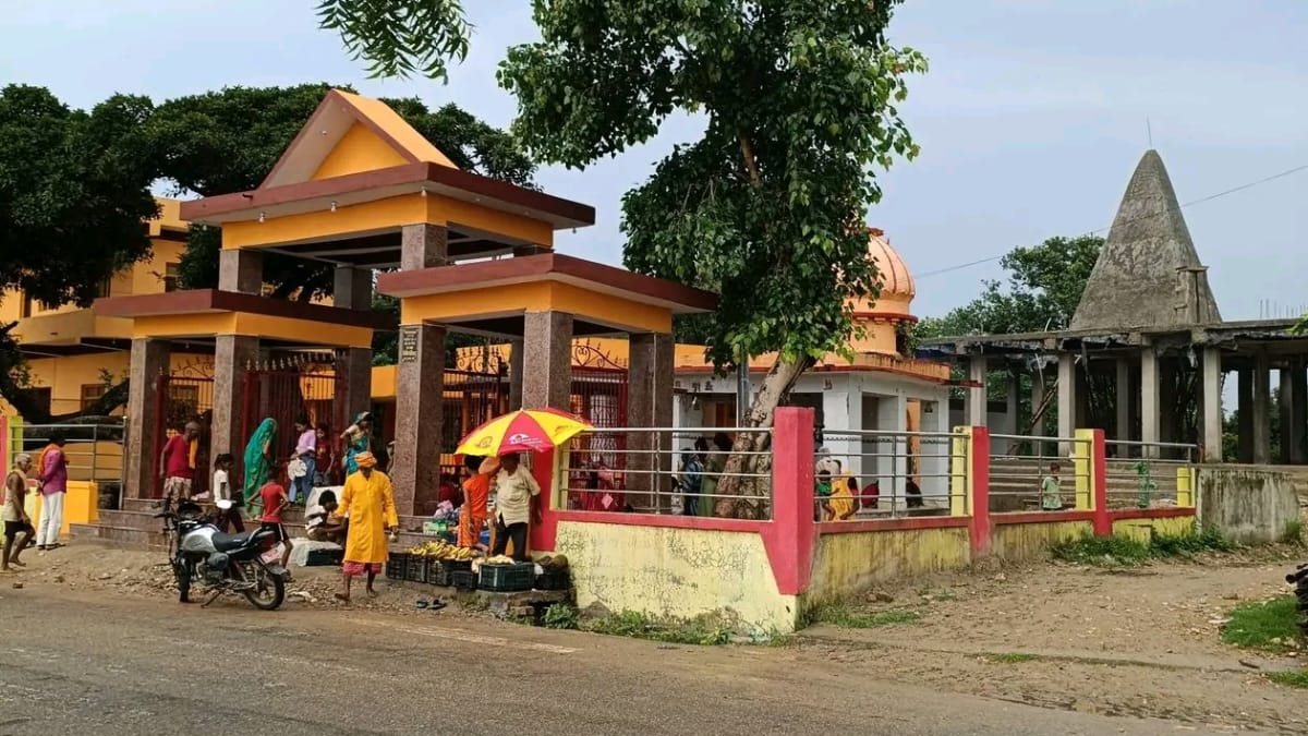 Shri Dineshwarnath Mahadev Mandir at Manara, Mahottari, seen from the road: the new yellow gateway, the domed shrine and the plain grey shikhar beside it